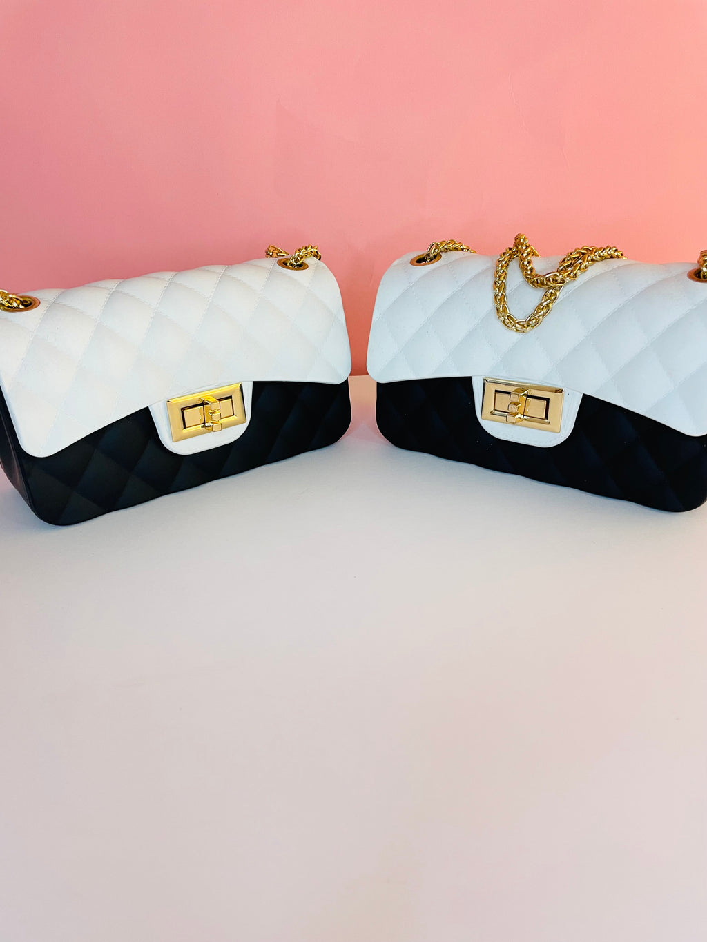 Small black and white jelly swing handbag with gold chain straps, gold hardware turn lock closure