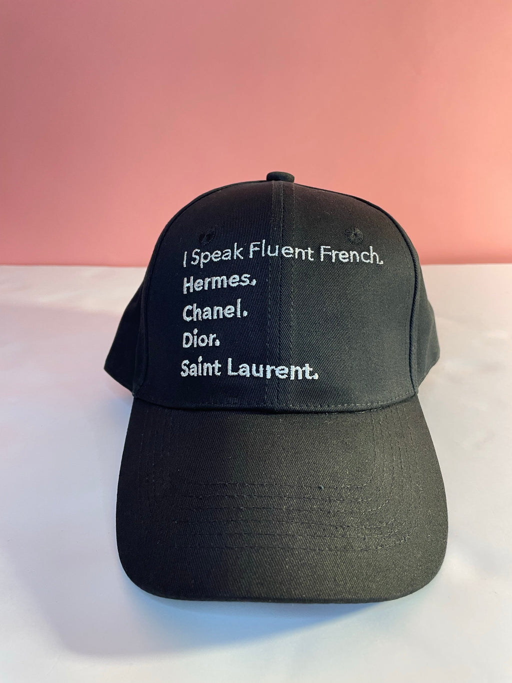 No matter if you washed your hair or not, this on trend I Speak Fluent French hats will help save the day. Our hats are sporty, chic, trendy and perfect for adding more detail to your look. Hats are essential part of your wardrobe and what better hat than this! Pair it with a bowie, Mimi, hoodie or crew neck to complete the look! Color: Black/ white lettering   Product Details: - 100% Cotton - Curved Brim - Hand Wash - Adjustable back strap